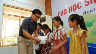 Đại diện Chi hội Nhà báo thường trú tại Bình Định tặng quà cho các em học sinh vượt khó học giỏi. Ảnh: Đức Anh